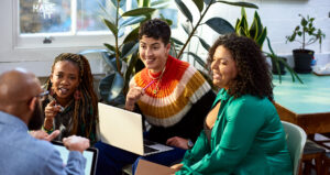 Business women talking to male colleague, informal meeting